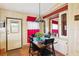 Well-lit dining room features hardwood flooring, a stylish chandelier and access to the backyard at 5409 Antigua Dr, Zephyrhills, FL 33541