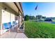 Charming single-story home features a well-manicured lawn and a cozy front porch with inviting blue chairs at 5409 Antigua Dr, Zephyrhills, FL 33541