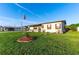 Attractive single-story home features a lush green lawn, a covered carport, and a charming front porch with blue chairs at 5409 Antigua Dr, Zephyrhills, FL 33541