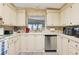 Charming kitchen boasts ample white cabinets, a stainless steel dishwasher, and lots of counter space at 5409 Antigua Dr, Zephyrhills, FL 33541