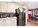 Bright kitchen featuring white cabinetry, stainless steel appliances, and a view to the dining room at 5409 Antigua Dr, Zephyrhills, FL 33541