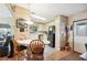 Open kitchen with white cabinetry, black refrigerator, breakfast table and a door to the backyard at 5409 Antigua Dr, Zephyrhills, FL 33541