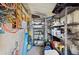 Small cluttered storage room with shelving and a small window at 5409 Antigua Dr, Zephyrhills, FL 33541