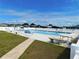 The community pool area includes lounge chairs and tables for relaxing, plus well-maintained grounds at 5409 Antigua Dr, Zephyrhills, FL 33541