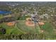 Expansive aerial view of multiple baseball fields surrounded by lush greenery and trees at 56 Bay Woods Dr, Safety Harbor, FL 34695