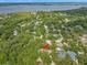 Panoramic aerial view of the neighborhood, showcasing lush greenery and a glimpse of the waterfront at 56 Bay Woods Dr, Safety Harbor, FL 34695