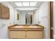 Bathroom featuring a double sink vanity, tile flooring, and large mirror with great lighting at 56 Bay Woods Dr, Safety Harbor, FL 34695