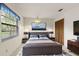Cozy bedroom with Queen bed, side tables, lamps, and an entertainment center at 56 Bay Woods Dr, Safety Harbor, FL 34695