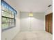 Empty bedroom with medium tone carpet, window, and closet at 56 Bay Woods Dr, Safety Harbor, FL 34695