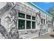 A building side-wall featuring a modern mural that depicts different human faces at 56 Bay Woods Dr, Safety Harbor, FL 34695