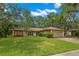Charming single-story home with well-maintained lawn, two-car garage and mature trees at 56 Bay Woods Dr, Safety Harbor, FL 34695