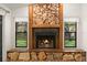 Close-up of stone fireplace, complemented by side windows providing natural light in the living space at 56 Bay Woods Dr, Safety Harbor, FL 34695