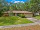 Charming single-story home with stone accents, mature landscaping, and a well-maintained lawn at 56 Bay Woods Dr, Safety Harbor, FL 34695