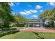 Community gazebo with benches surrounded by green grass and large trees in a park setting at 56 Bay Woods Dr, Safety Harbor, FL 34695