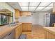 Bright kitchen with wooden cabinets, stainless steel sink, and view of a spacious room at 56 Bay Woods Dr, Safety Harbor, FL 34695