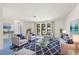 Bright living room featuring matching furniture, large window, and stylish blue accents at 56 Bay Woods Dr, Safety Harbor, FL 34695