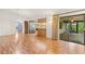 Bright living room with open layout showcasing the kitchen, stainless steel refrigerator, and screened porch access at 56 Bay Woods Dr, Safety Harbor, FL 34695