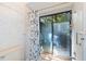 Bathroom shower with glass door to outdoor area and blue and white curtain at 56 Bay Woods Dr, Safety Harbor, FL 34695