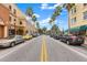 Downtown Safety Harbor street with palm trees, sidewalks, storefronts, and parked cars on a sunny day at 56 Bay Woods Dr, Safety Harbor, FL 34695