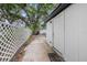 Backyard features mature landscaping and a concrete walkway leading to the back of the property at 5801 92Nd N Ave, Pinellas Park, FL 33782