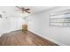 Bright bedroom features sleek wood floors, a ceiling fan, and ample closet space at 5801 92Nd N Ave, Pinellas Park, FL 33782