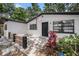 Close up of the home's front door with black trim and a small front patio area at 5801 92Nd N Ave, Pinellas Park, FL 33782