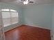 A view of a spare bedroom with light-blue walls and hardwood floors at 5815 Heronview Crescent Dr, Lithia, FL 33547