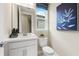 Well-lit powder room featuring modern fixtures, a stylish mirror, and a commode at 727 Steel Dr, Apollo Beach, FL 33572