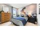 Stylish bedroom features a sports-themed mural and a blue-toned color scheme, creating a vibrant and modern living space at 727 Steel Dr, Apollo Beach, FL 33572