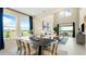 Well-lit dining area connects to the living room with high ceilings and ample natural light at 727 Steel Dr, Apollo Beach, FL 33572