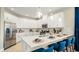 Contemporary kitchen with stainless steel appliances, white cabinets, and a breakfast bar at 727 Steel Dr, Apollo Beach, FL 33572