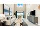 Bright, open-concept living room with high ceilings and sliding glass doors to the outdoor patio at 727 Steel Dr, Apollo Beach, FL 33572