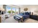 Serene main bedroom featuring water views from windows, tray ceiling, and chic furnishings at 727 Steel Dr, Apollo Beach, FL 33572