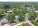 An aerial view showcases this home nestled among mature trees, with waterway access at 7300 Mackerel Ln, Hudson, FL 34667