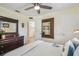 Charming bedroom with ceiling fan, wood floors, and dresser with mirror at 7300 Mackerel Ln, Hudson, FL 34667