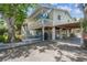 Charming two-story waterfront home with a spacious balcony, fenced yard, and covered parking at 7300 Mackerel Ln, Hudson, FL 34667