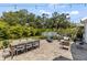 Spacious backyard with lush landscaping, a dining table, and a lounge chair at 7309 S Shamrock Rd, Tampa, FL 33616