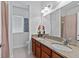 Bathroom featuring double sinks with granite countertops and a large mirror at 7309 S Shamrock Rd, Tampa, FL 33616