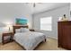 Serene bedroom with a queen bed, two nightstands, and natural light from the window at 7309 S Shamrock Rd, Tampa, FL 33616