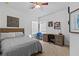 Cozy bedroom featuring a ceiling fan, neutral-toned walls, and a comfortable bed at 7309 S Shamrock Rd, Tampa, FL 33616