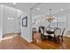 Elegant dining room with a stylish chandelier, seating for six, and an open concept design at 7309 S Shamrock Rd, Tampa, FL 33616