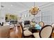 Dining room featuring a chandelier and large windows, seamlessly connected to the bright living room at 7309 S Shamrock Rd, Tampa, FL 33616
