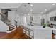 Bright kitchen features a large island, breakfast bar, stainless appliances, and custom white cabinets at 7309 S Shamrock Rd, Tampa, FL 33616