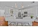 Bright kitchen featuring white cabinets, quartz countertops and counter seating at 7309 S Shamrock Rd, Tampa, FL 33616