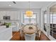 Eat-in kitchen nook with a round table and chairs set near French doors, with abundant natural light at 7309 S Shamrock Rd, Tampa, FL 33616