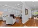 Bright living room with hardwood floors, recessed lighting, large windows and adjacent dining space at 7309 S Shamrock Rd, Tampa, FL 33616