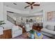 Open-concept living space with modern decor, fireplace, island kitchen, and connected breakfast nook at 7309 S Shamrock Rd, Tampa, FL 33616