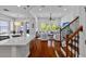 Open floor plan with hardwood floors seamlessly connects kitchen, living, and staircase at 7309 S Shamrock Rd, Tampa, FL 33616