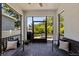 Covered patio featuring comfortable seating and views of the backyard at 7309 S Shamrock Rd, Tampa, FL 33616