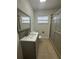 Bathroom featuring a modern vanity, tile flooring, and a glass-enclosed shower at 7631 43Rd St N, Pinellas Park, FL 33781